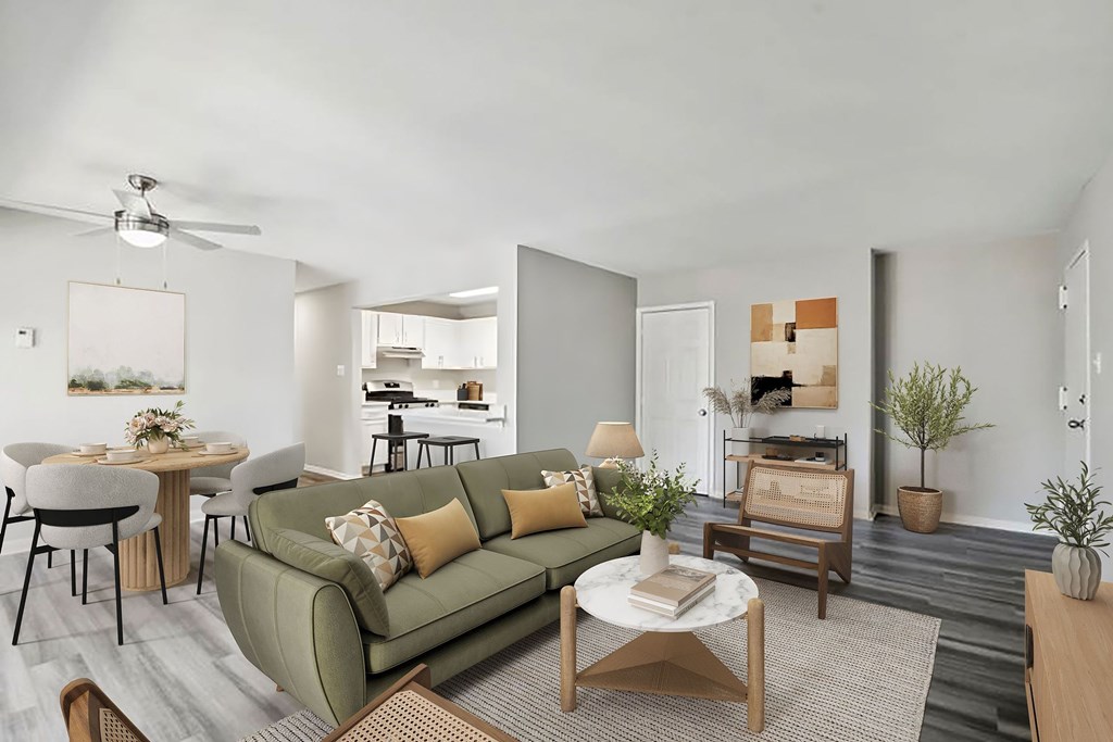 A living room with a green couch and a coffee table at Shenandoah Station Apartments, Triangle, VA, 22172