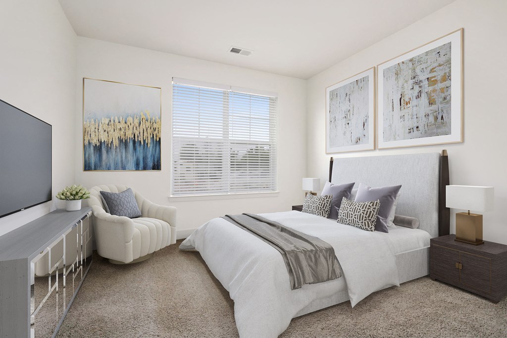 a bedroom with a bed and a chair and a television