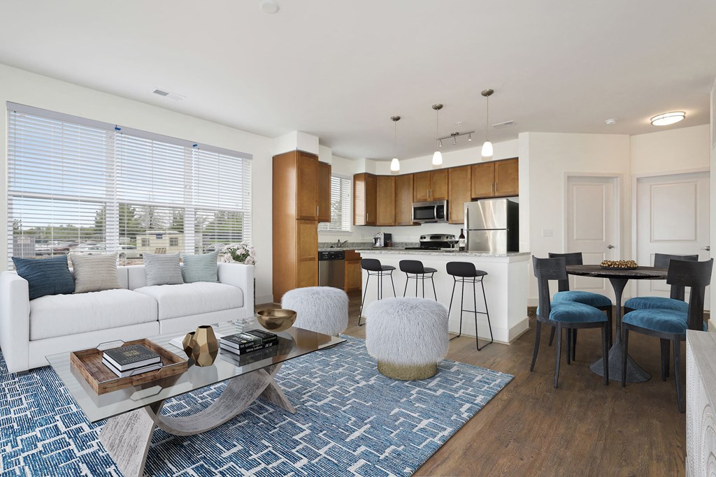 a living room and kitchen with a couch and a table