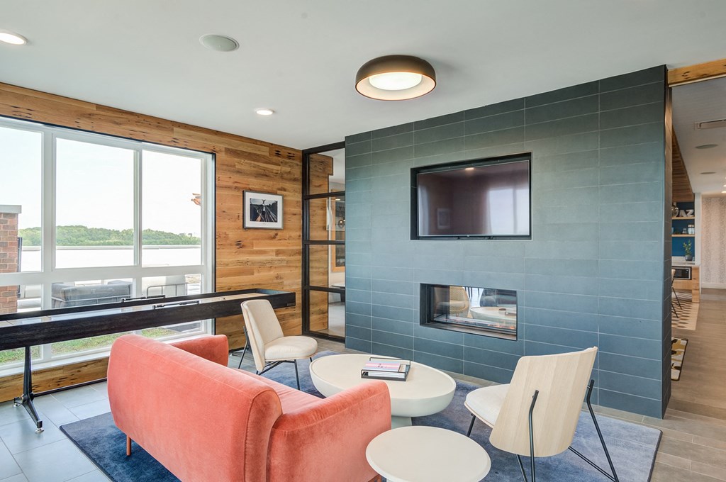 a living room with a fireplace and a large window at Vesta Parkside, Washington, Washington