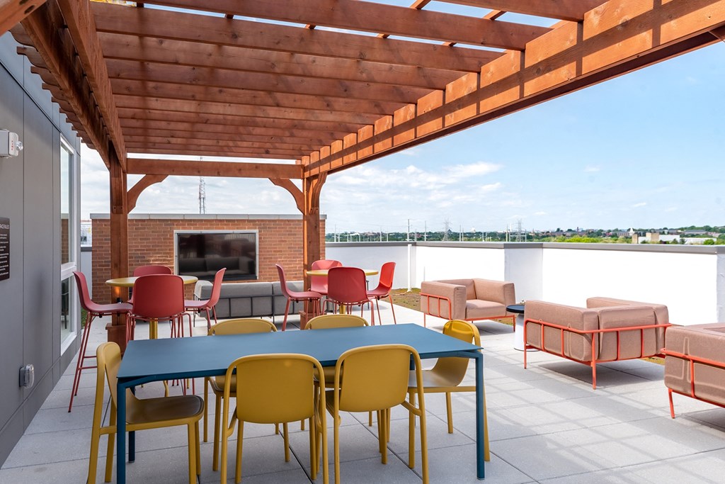 a patio with a fireplace and tables and chairs  at Vesta Parkside, Washington, DC, 20019