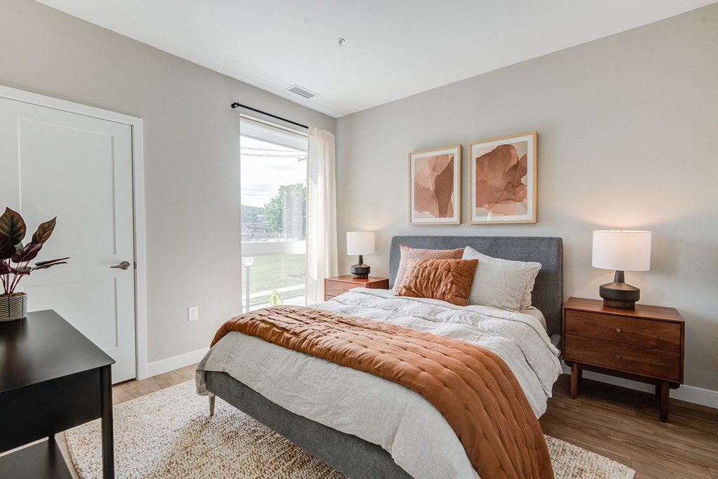 a bedroom with a bed and two night stands with lamps at Vesta Parkside, Washington, DC, 20019