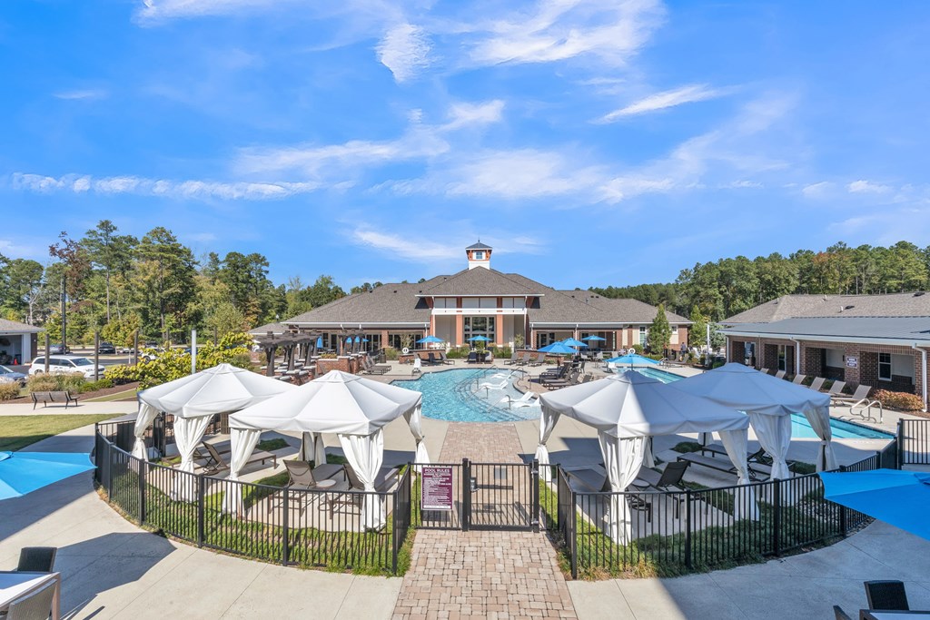 A Pool Area With Umbrellas at The Aster Apartments, Cary, NC