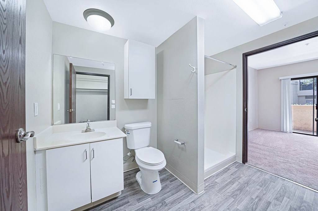 a bathroom with a toilet and a sink and a shower