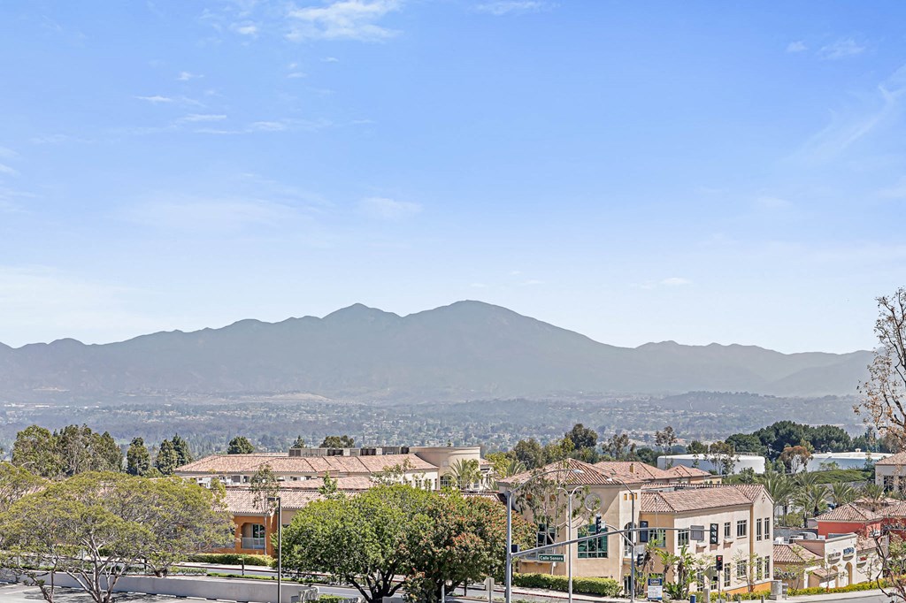 the view of the city and mountains from the roof of a house