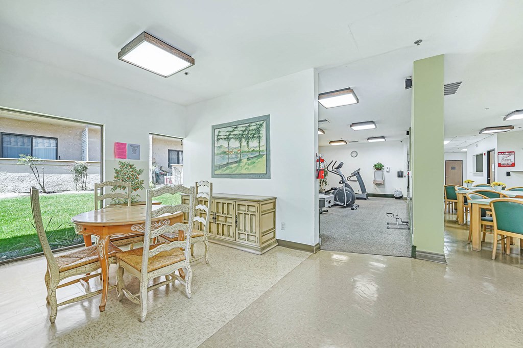 a dining room with a table and chairs and a glass door