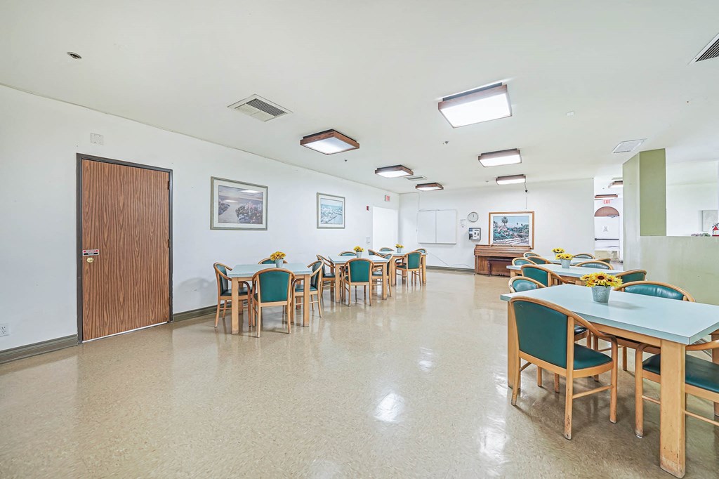 a dining room with tables and chairs and a door