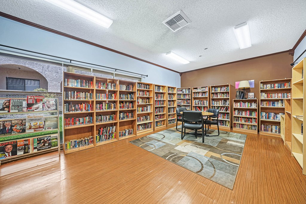 a library with a table and chairs in it