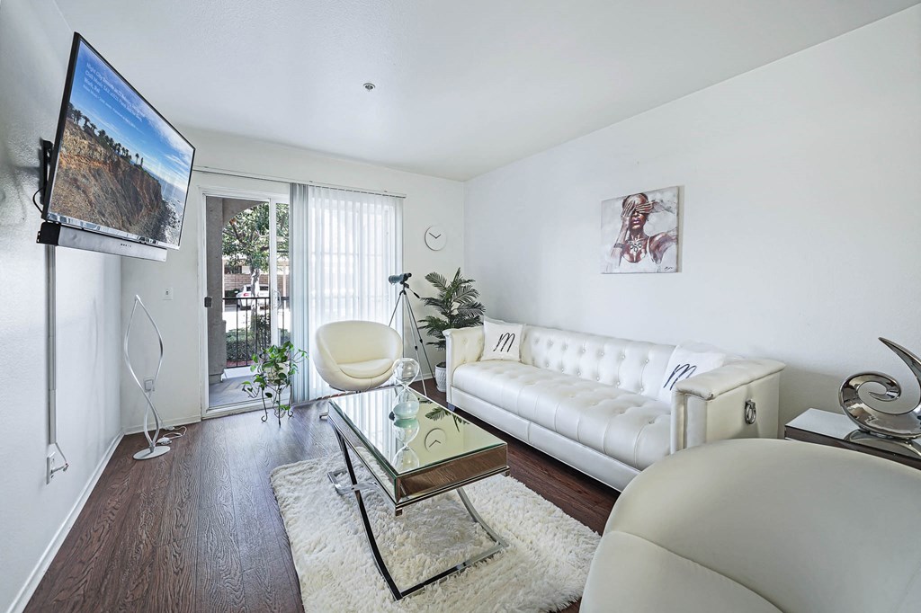 a living room with a white couch and a tv