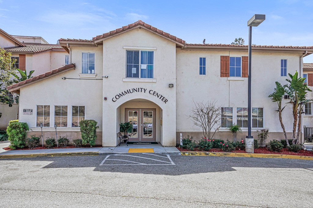 the front of the community center building with a parking lot