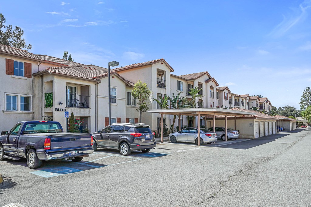a parking lot with cars parked in front of a building