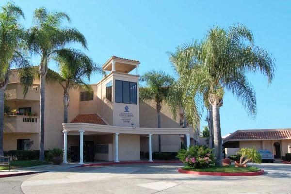 a building with palm trees in front of it