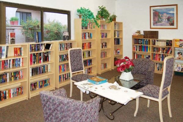 a library with a table and chairs and bookshelves