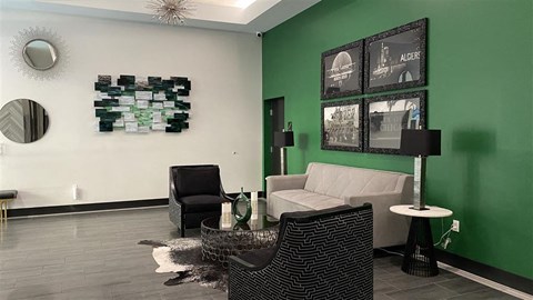 a living room with a green wall and a white couch