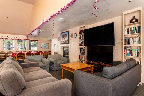 A living room with grey couches and a television.
