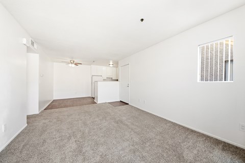 A spacious, empty room with a carpeted floor and a window with blinds. at Whispering Fountains Diamond Bar, Diamond Bar, CA 91765