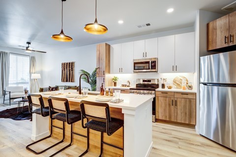 Kitchen with stainless-steel appliances at Tempo Nine Mile Station in Aurora, Colorado