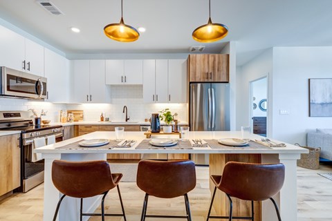 Kitchen with island at Tempo Nine Mile Station in Aurora, Colorado