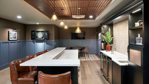 Epoque Golden game room with bar seating, dartboard, television, lounge table and warm wood finishes.