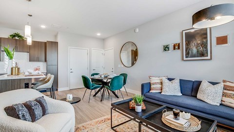 A living room with a blue couch and a coffee table.