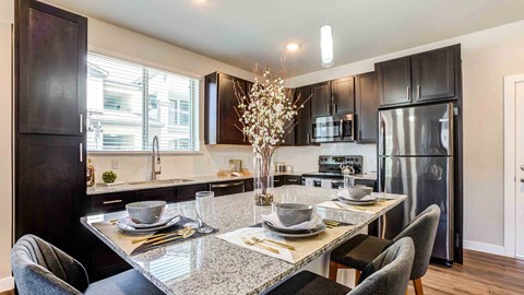 an open kitchen and dining room with a table and chairs