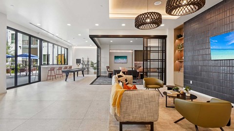 A modern living room with a yellow chair and a flat screen TV mounted on the wall.