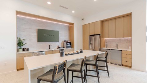 A modern kitchen with a dining table and chairs.