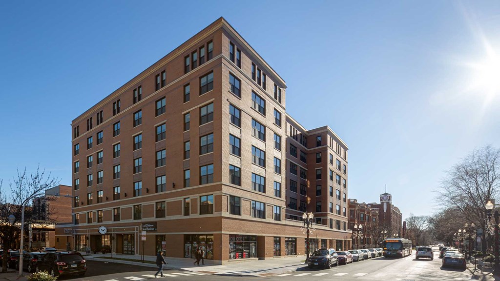 Looking at the exterior of Wrigleyville Lofts from across the street on a clear, sunny day.