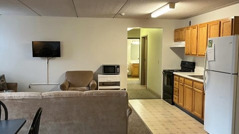 A kitchen area with a refrigerator, microwave, and oven.