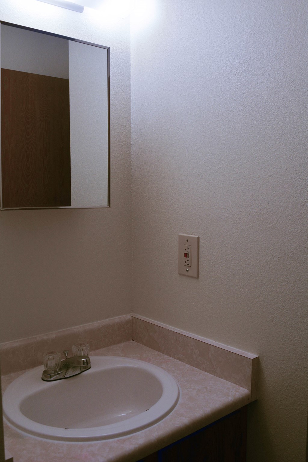 a small bathroom with a sink and a mirror