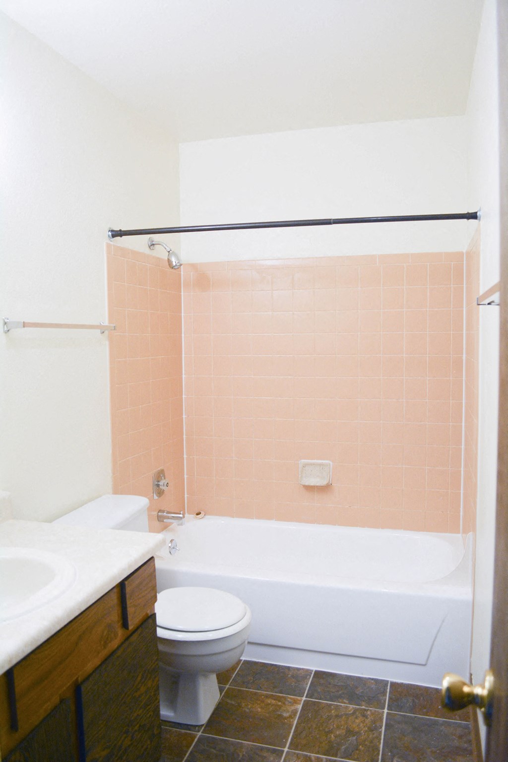 a bathroom with a toilet and a tub and a sink