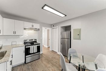 a kitchen and dining room with a glass table