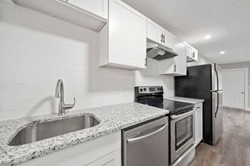 a kitchen with stainless steel appliances and granite counter tops