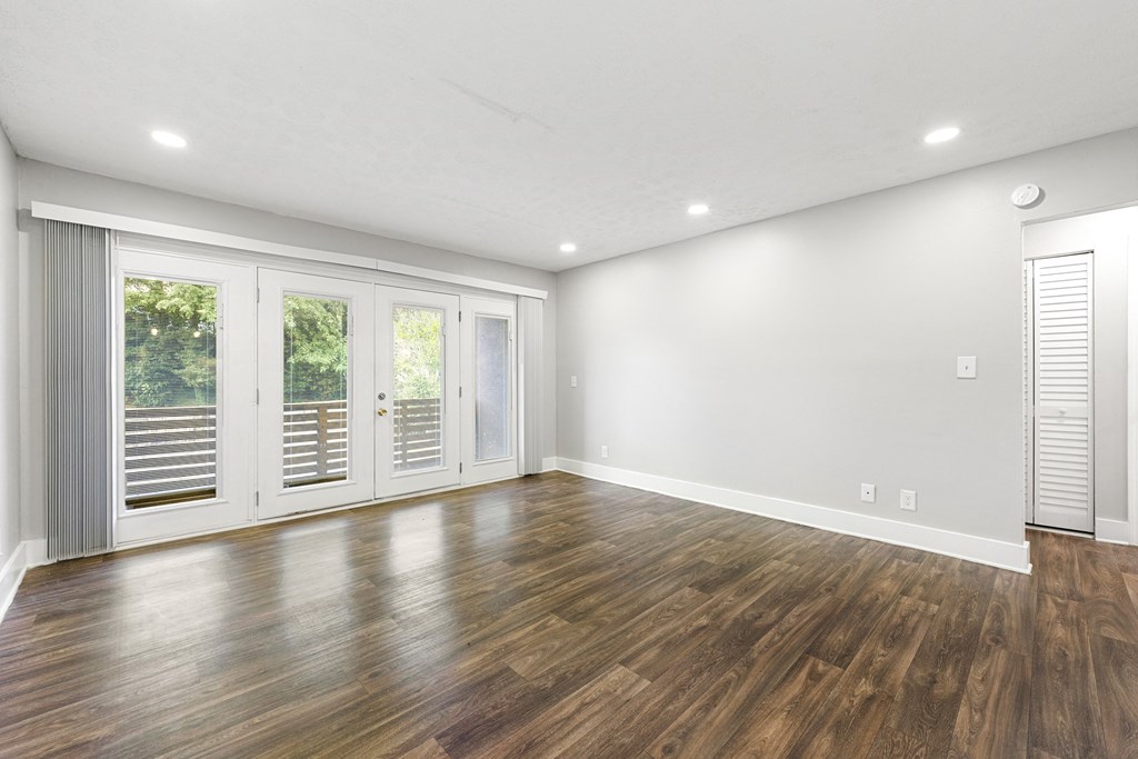 Living room with updated flooring and private patio at Balfour Chastain, Sandy Springs, GA