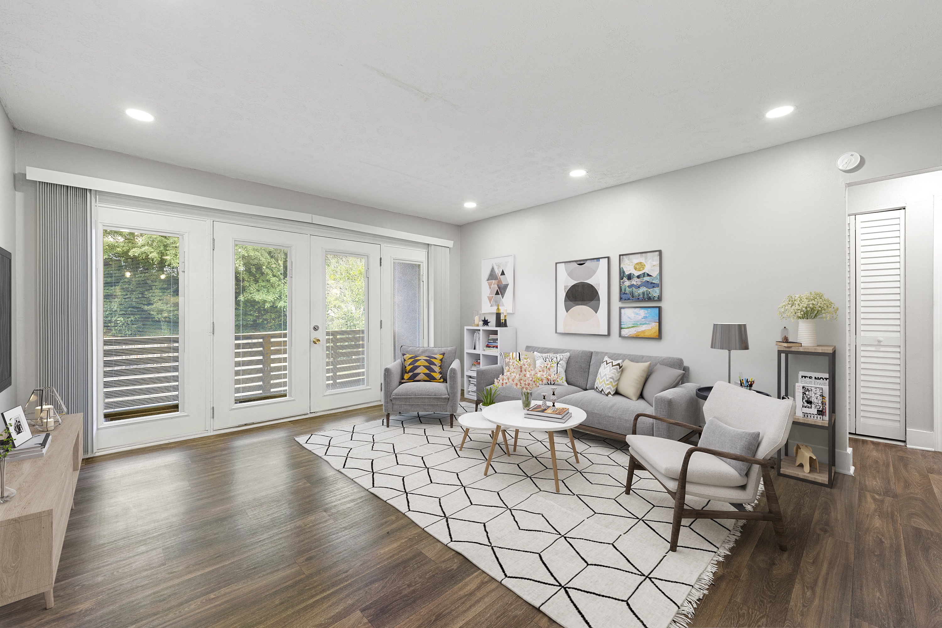 a living room with a gray couch and a white rug