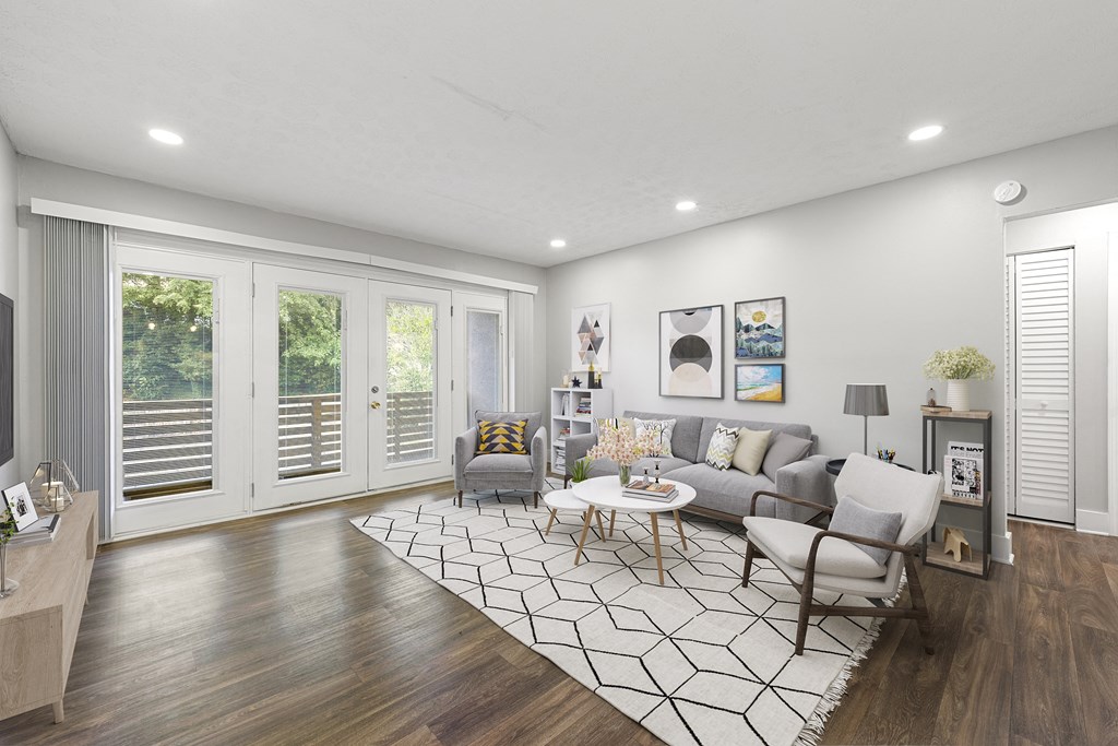Living room with updated flooring and private patio at Balfour Chastain, Sandy Springs, GA