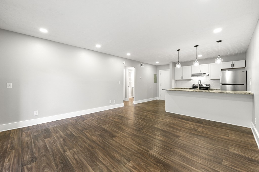 Living room with updated flooring and private patio at Balfour Chastain, Sandy Springs, GA