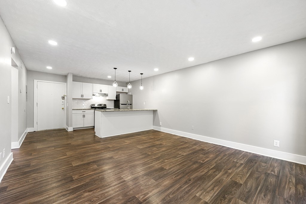 Living room with updated flooring and private patio at Balfour Chastain, Sandy Springs, GA