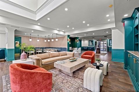 A living room with a red chair and a white couch.