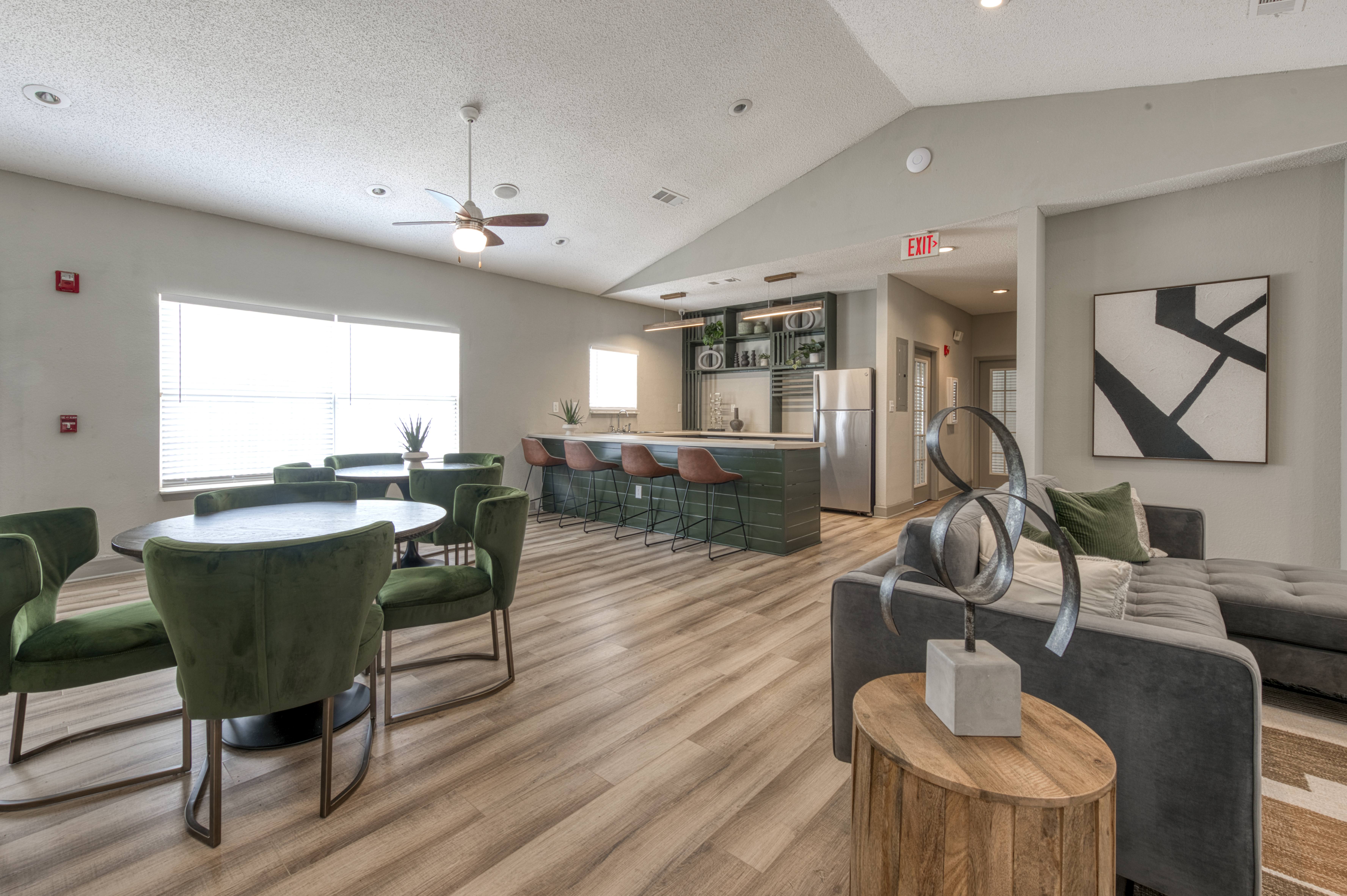A modern living room with a dining table and chairs.