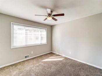 an empty room with a ceiling fan and a window at Balfour Chastain, Sandy Springs, GA