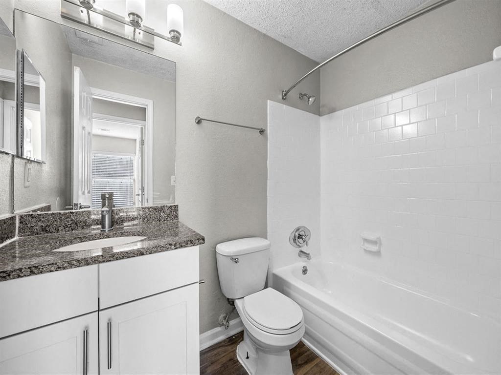 Renovated bathroom with granite top vanity and stylish light fixture.  at Concord Crossing, Georgia, 30082