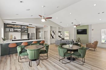 A modern dining room with a bar area and a television.at Eastlake Gardens, Georgia, 30032