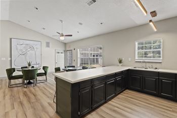 A kitchen with a table and chairs in the middle of the room.at Eastlake Gardens, Decatur, GA 30032