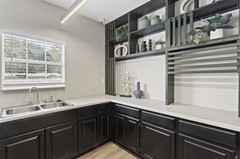 A kitchen with black cabinets and a white countertop.at Eastlake Gardens, Decatur, 30032