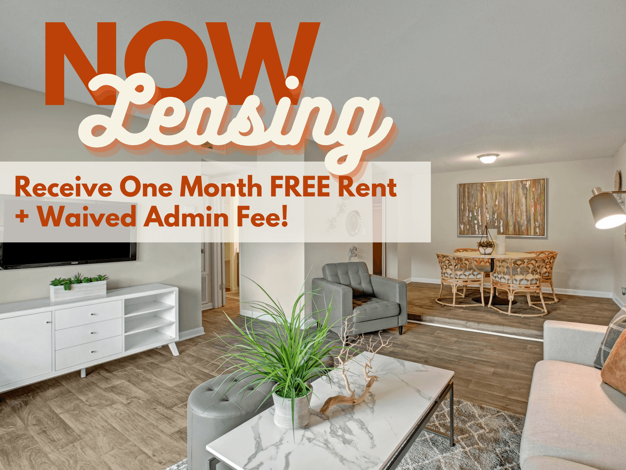 A living room with a white sofa set and a coffee table with a plant on it.