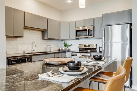 a kitchen with stainless steel appliances and a granite counter top