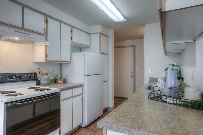 Kitchen with plank flooring and white cabinetry at Parkside Apartments, Gresham, OR