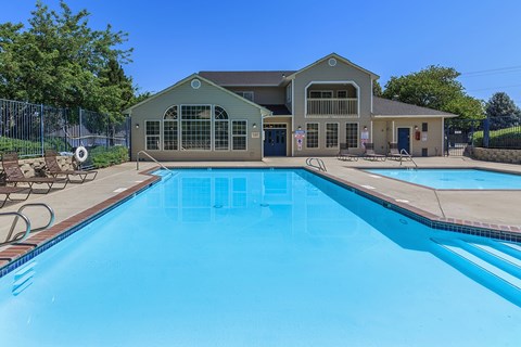 A large swimming pool in front of a building.