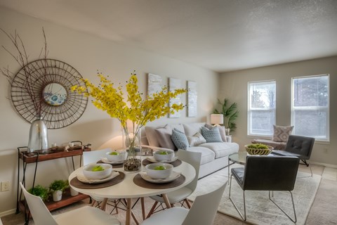 A dining room with a white table and chairs.